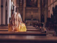 Woman alone in empty church. 