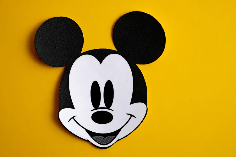 Black and white face of Mickey Mouse out of paper on a yellow background. ?w=200&h=150