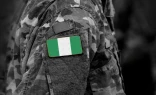 Flag of Nigeria on soldiers arm.