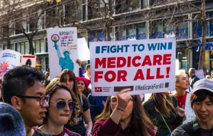 January 19, 2019 San Francisco / CA / USA - Participant to the Women's March event holds "Medicare for all" sign while marching on Market street in downtown San Francisco.   Shutterstock