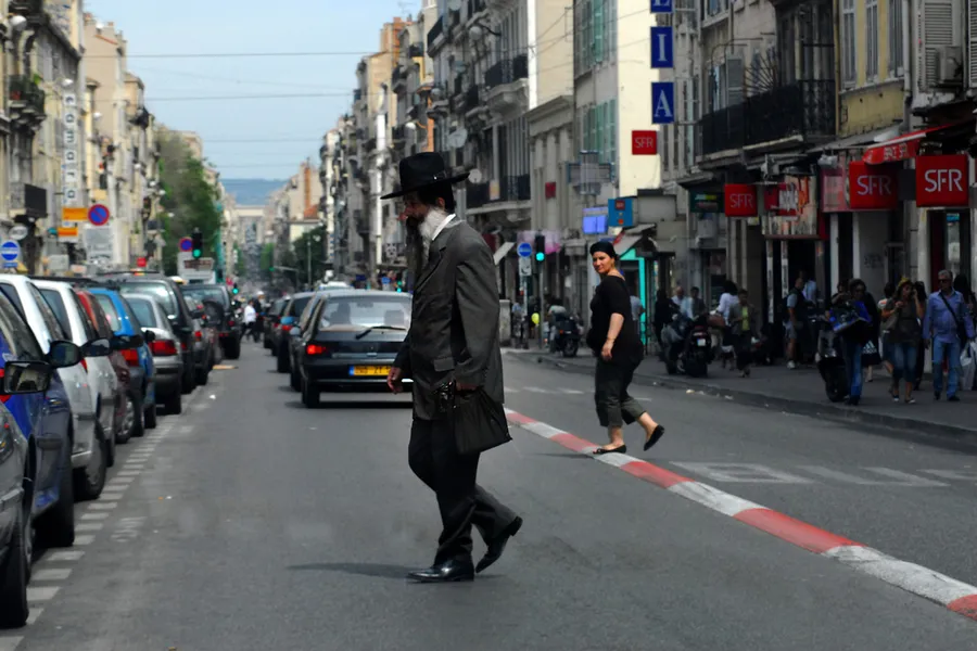 An Orthodox Jewish man cross the street in Marseille, France. ChameleonsEye / Shutterstock?w=200&h=150