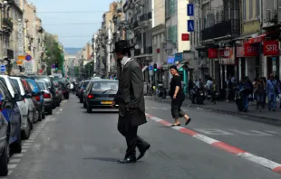 An Orthodox Jewish man cross the street in Marseille, France. ChameleonsEye / Shutterstock 