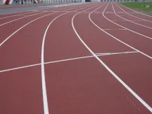 Track lanes in a stadium. Via Shutterstock