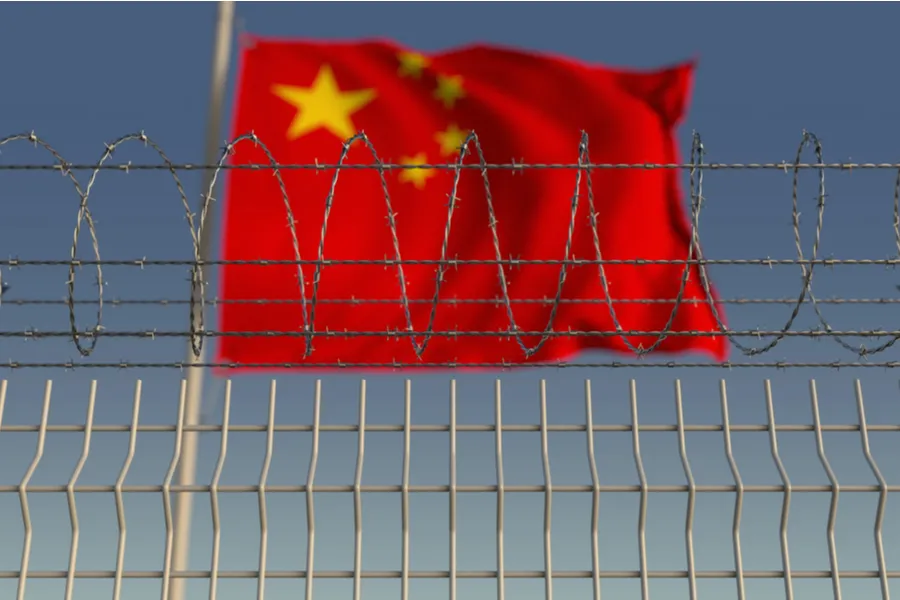 Chinese flag behind barbed wire fencing. ?w=200&h=150