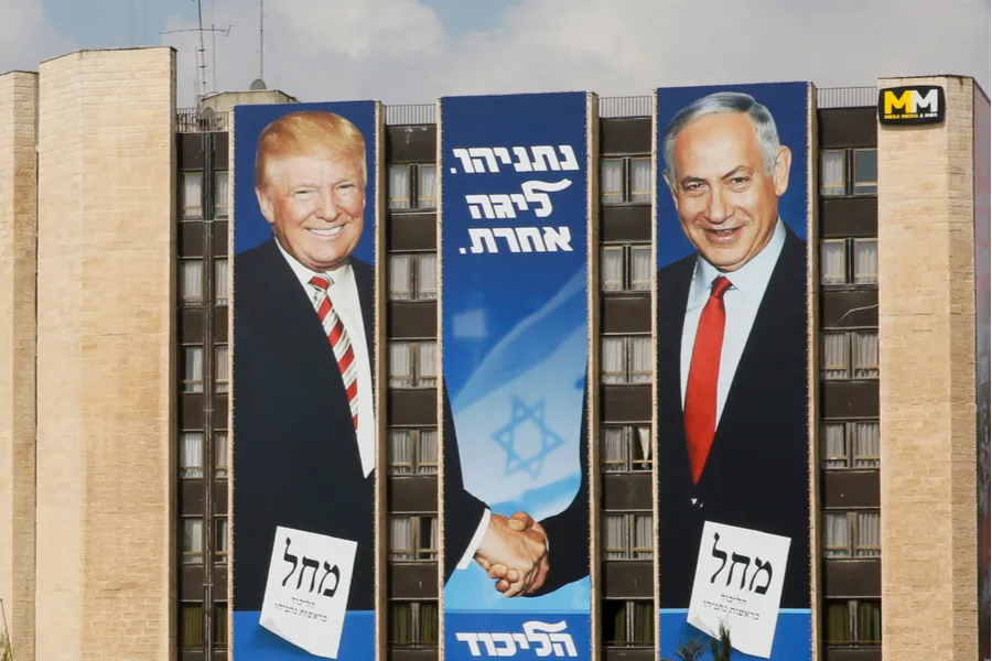 Banner for the Likud party showing President Donald Trump shaking hands with Prime Minister Benjamin Netanyahu on a building in Jerusalem. ?w=200&h=150