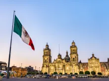 Flagpole and the Metropolitan Cathedral of the Assumption of Virgin Mary in Mexico City, Mexico. 