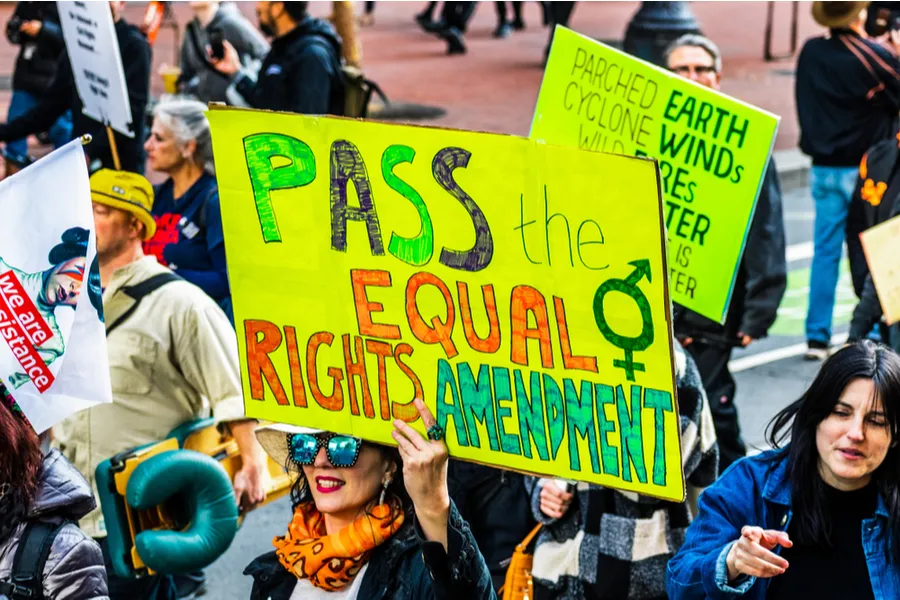 A participant in the Women's March event Jan. 18, 2020, in San Francisco holds a "Pass the Equal Rights Amendment" sign while marching.?w=200&h=150