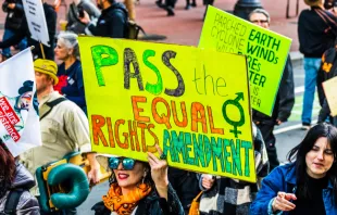 A participant in a Women's March event Jan. 18, 2020, in San Francisco holds a "Pass the Equal Rights Amendment" sign while marching. Credit: Sundry Photography/Shutterstock