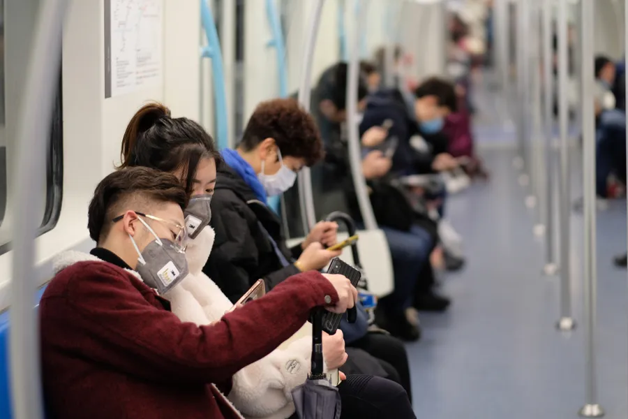People wearing surgical mask sitting in subway in Shanghai, China. ?w=200&h=150