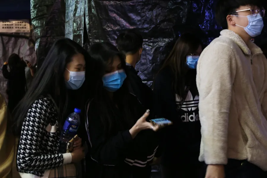 Pedestrians wear surgical masks in Hong Kong following coronavirus outbreak. ?w=200&h=150