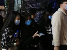 Pedestrians wear surgical masks in Hong Kong following coronavirus outbreak. 