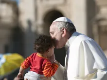 Pope Francis on the popemobile kiss child in St. Peter's Square. 