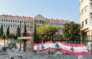 Lebanese flag on barbed wire in front of the Lebanese government seat of Grand Serail.   JossK/Shutterstock. Credit: