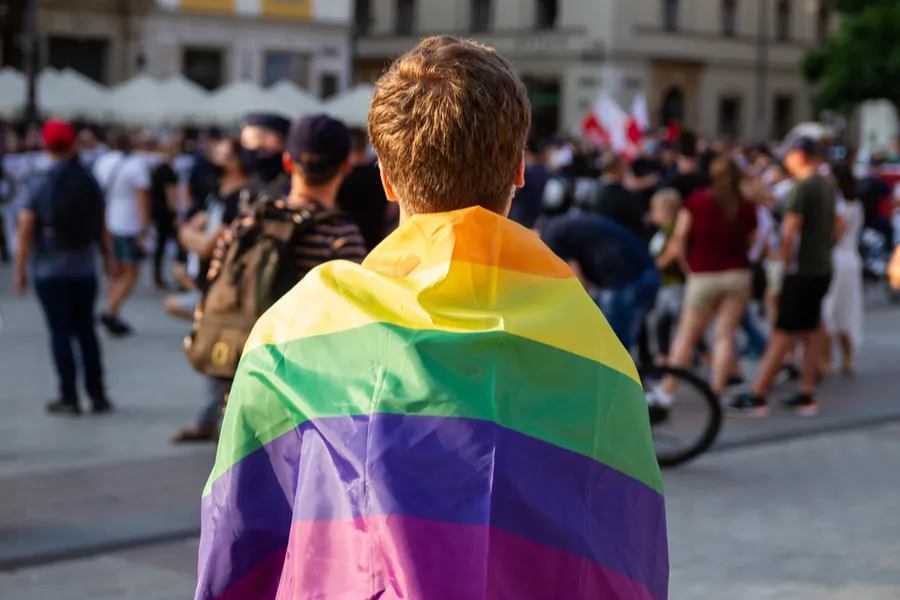 Young man with rainbow flag during Krakow Pride parade, Aug. 29, 2020. ?w=200&h=150