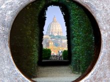 St. Peter's Basilica from the keyhole on Aventino Hill, Rome Italy. Via Shutterstock
