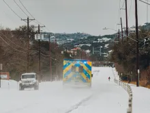 An ambulance drives amid snow in Austin, Texas, Feb. 16, 2021. Credit: ChangJr LIN/Shutterstock.