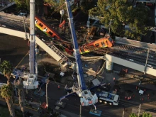 Construction crews attend to the collapsed cars of the elevated metro line in Mexico City, May 4, 2021. Credit: Nick_John_07/Shutterstock.