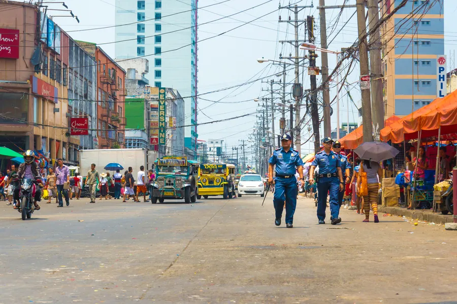 Police officers patrol city streets in Philippines. ?w=200&h=150
