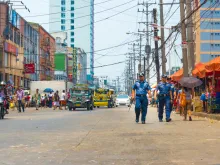 Police officers patrol city streets in Philippines. 