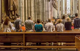 People in the pews at Cologne Cathedral, Germany.   travelview/Shuttertock