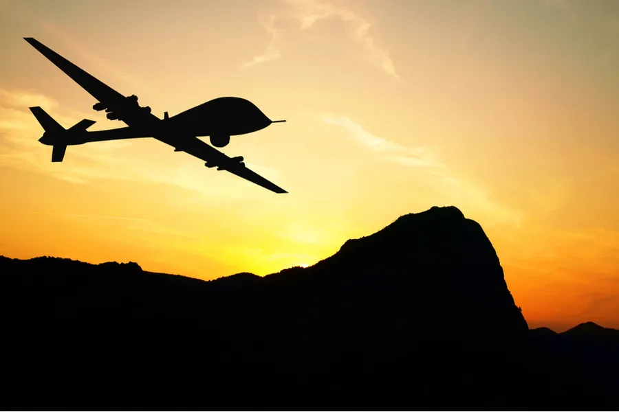 Drone flying over mountains on sunset background. Via Shutterstock?w=200&h=150