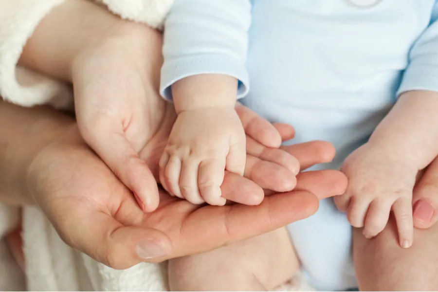 Parents holding child's hand. ?w=200&h=150