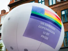 Group of the U.S. Embassy in Denmark holds a balloon with the American flag adapted to the LGBT flag at the Copenhagen Pride Parade on Aug. 15, 2015  Credit: Giorgio Caracciolo/Shutterstock