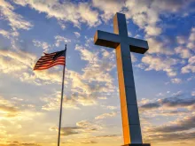 Flag and cross at sunset. 