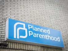 Blue and white sign above the entrance for the Planned Parenthood clinic in Newton, NJ. Via Shutterstock.