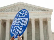 A Pro-choice activist holds a sign in front of the Supreme Court in Washington, DC on June 27, 2016. 