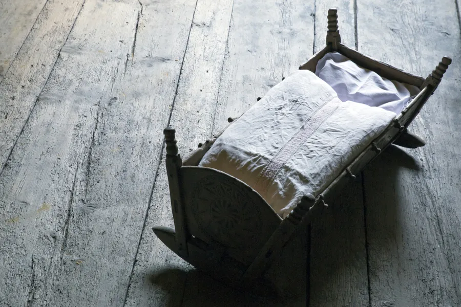 Empty wooden crib. Image via Shutterstock?w=200&h=150