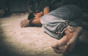 Man bound hand and foot, vicitim of human trafficking.   Shutterstock