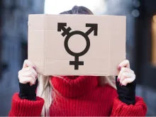 Woman holding transgender sign. Via Shutterstock