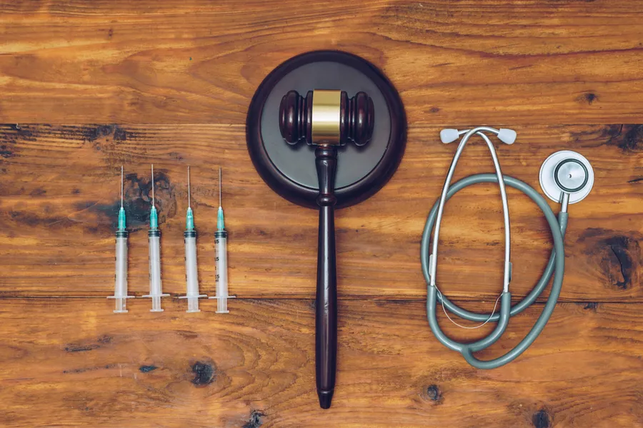 Syringes, stethoscope and judge gavel on wooden background. ?w=200&h=150
