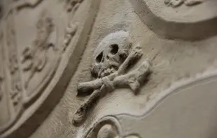 Memento mori skull on a marble wall.   DavidSchwimbeck/Shutterstock