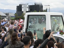 Pope Leo XIV interacts with a baby before celebrating Mass in Beirut, Lebanon, on Dec. 2, 2025.