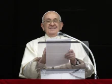 Pope Francis speaks to pilgrims gathered in St. Peter's Square for the Angelus on the solemnity of All Saints on Nov. 1, 2023.