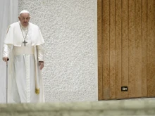 Pope Francis uses a cane to walk at his general audience on Nov. 29, 2023.