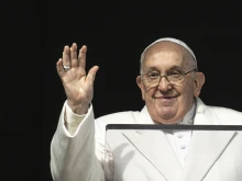 Pope Francis waves from the window of the Apostolic Palace as he gives his Angelus address for the solemnity of the Immaculate Conception on Friday, Dec. 8, 2023.