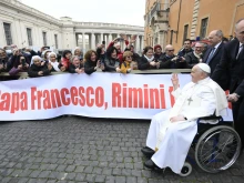 Pope Francis greets the faithful from his wheelchair during his Feb. 28, 2024, general audience at the Vatican.
