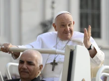 Pope Francis waves to pilgrims in St. Peter's Square at the Vatican at his general audience on Sept. 13, 2023.