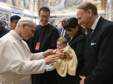 Pope Leo XIV greets a baby during an audience with the Pontifical John Paul II Institute for Studies on Marriage and the Family at the Vatican on Friday, Oct. 24, 2025.