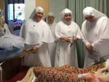 The Sister Servants of Mary hold a procession with the statue of Our Lady of the Assumption at Mary Health of the Sick Convalescent Hospital in Newbury Park, California.