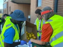 Volunteers prepare and distribute food to families coming through the drive-through distribution site at the Catholic Charities Diocese of Galveston-Houston Guadalupe Center, a food pantry near central Houston.