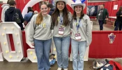 Lucy Snipes, Anne Young, and Presley Hilderbrand from Columbus, Georgia tour exhibits during the first night of NCYC 2025 on Nov. 20, 2025, at the Indiana Convention Center in Indianapolis.