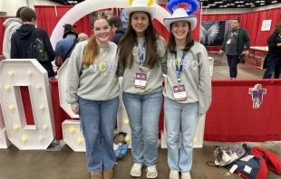 Lucy Snipes, Anne Young, and Presley Hilderbrand from Columbus, Georgia tour exhibits during the first night of NCYC 2025 on Nov. 20, 2025, at the Indiana Convention Center in Indianapolis. Credit: Tessa Gervasini / CNA
