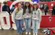 Lucy Snipes, Anne Young, and Presley Hilderbrand from Columbus, Georgia tour exhibits during the first night of NCYC 2025 on Nov. 20, 2025, at the Indiana Convention Center in Indianapolis.