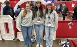 Lucy Snipes, Anne Young, and Presley Hilderbrand from Columbus, Georgia tour exhibits during the first night of NCYC 2025 on Nov. 20, 2025, at the Indiana Convention Center in Indianapolis.