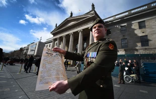 An Irish soldier holds the a copy of the 1916 Proclamation of the Irish Republic outside the General Post Office, the scene of the 1916 Easter Rising, in Dublin on March 27, 2016 as part of a program of commemorative events to mark the 100th anniversary of the Easter Rising. Credit: Charles McQuillan/Getty Images