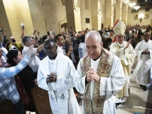 Auxiliary Bishop Silvio Báez, at right in the background, and Father Edwing Román, foreground center, both of the Archdiocese of Managua in Nicaragua, process into St. Vincent de Paul Church in Exposition Park in Los Angeles for Mass on Jan. 6, 2024.